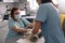 Skilled doctor performs ultrasound investigation while assistant holds animal in vet clinic