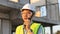 Skilled engineer inspects factory construction and uses a radio to chat with colleagues working on the field