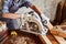 Skilled female carpenter using a circular saw. Woman worker in the carpenter workroom renovation. Small business concept