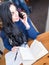 Skilled female designer having phone conversation in coffee shop consulting about strategy planning for project