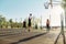 Skilled guy preparing for throwing ball into basket, while spending time with his friends outdoors on playground