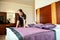 Skilled hotel cleaning maid makes bed look perfect