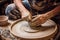 A skilled man demonstrates the traditional pottery crafting process by making a pot on a potters wheel, potter using a pottery