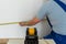 A skilled person marks a point on the wall marked with an electronic laser