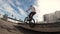 Skilled teen guy BMX rider practices flips, jumps and spins on bike in urban area