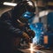 Skilled Welder Engaged in Precision Metalwork at Industrial Workshop During Evening Hours