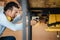 Skilled woodworker working on woodworking machines in carpentry shop, Male carpenter adjusting circular saw workbench