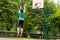 Skilled young basketball player shooting a goal