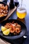 Skillet roasted jumbo shrimp on a black plate