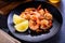 Skillet roasted jumbo shrimp on a black plate