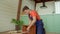 Skillful African American man assembling DIY bedside table using power tool