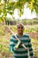 Skillful Colombian gardener with hoe at smallholding