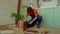 Skillful handsome African American man assembling DIY furniture with tool