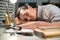 Skillful male employee falling asleep during work