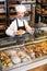 Skillful male pastry maker demonstrating croissant