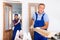 Skillful man builder carrying wooden planks in apartment