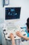 Skillful sonographer using ultrasound machine at work