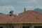 Skillful workers tiling on rooftop of a new house.