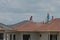 Skillful workers tiling on rooftop of a new house.