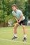 Skillful young tennis player ready to beat ball