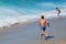 Skim Boarder preparing to ride a shore break wave at Aliso Beach in Laguna Beach, California.