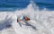 Skim Boarder riding a shore break wave at Aliso Beach in Laguna Beach, California.