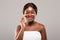 Skin Care Concept. Portrait Of Attractive African American Female Applying Moisturising Cream