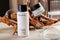 Skin care cosmetics French brand Academie Paris. Cream and cleanser for skin on wooden bark beige background in minimalist style