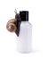 Skin care cosmetics with Snail mucus. One black snail climbing on a cosmetic cream or lotion bottle against white