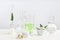 Skin care product, ingredients and laboratory glassware on table.