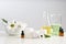 Skin care products, ingredients and laboratory glassware on table.