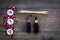 Skin care and relax. Cosmetics and aromatherapy concept. Rose oil and candles on dark wooden background top view