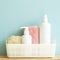 Skin care and spa concept. Bathroom bottle and towel in basket on wooden shelf