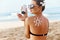 Skin care. Sun protection. Woman apply sun cream. Girl Holding Moisturizing Sunblock. Woman With Suntan Lotion On Beach In Form Of