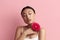 Skin Care Woman Posing with Red Flower. Asian Model Holding Flower