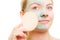 Skin care. Woman removing facial clay mud mask.