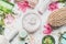 Skin cream with flowers petals and others body care cosmetic products and accessories on white background