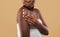 Skin Mousturising Concept. Closep Shot Of Young Black Woman Applying Body Lotion