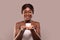 Skin Nourishing. Attractive Black Woman Holding Jar With Moisturising Cream In Hands