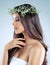 Skin thats so soft, so supple, so touchable. Studio shot of a beautiful young woman wearing a floral head wreath.