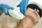 Skin treatment Concepts. Professional Cosmetologist Treating Female Human Skin With Laser Using Professional Equipment