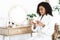 Daily Skincare. Beautiful Black Woman Using Moisturising Cream For Skin At Home