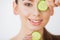 Skincare. Beautiful young woman with cucumbers on eyes