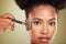 Skincare, beauty and black woman with face roller, facial massage for glowing healthy skin. Wellness, dermatology and