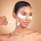 Skincare, eye patch and roller with Indian woman in studio for facial, spa treatment and glow. Self care, cosmetics and