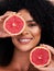 Skincare, face and portrait of black woman with grapefruit in studio for health and dermatology. Fruit, wellness and