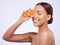 Skincare, orange and woman in studio for vitamin c, treatment and cosmetics on purple background. Smile, fruit and girl