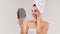 Skincare Treatments. Middle aged lady with towel on head looking in mirror