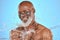 Skincare, water and portrait of black man with facial on blue background in studio for wellness, spa and cleanse