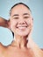 Skincare, water splash and face of woman cleaning in studio isolated on a blue background. Shower, hygiene and portrait